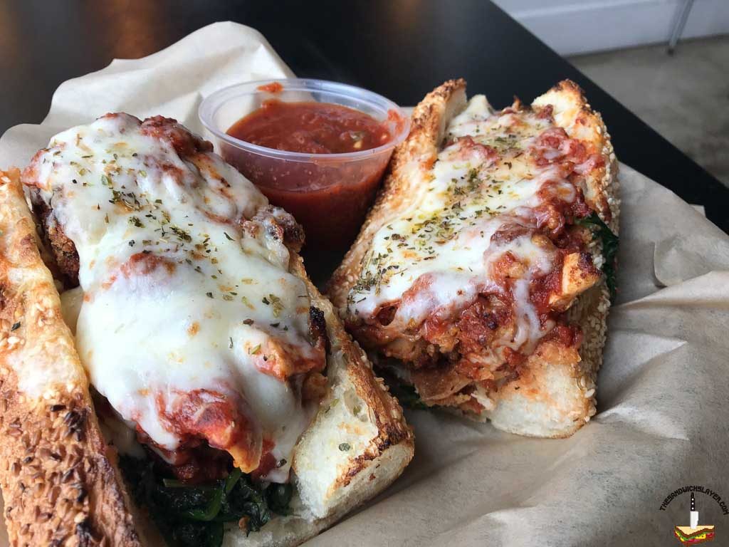 Sliced fried chicken, sautéed greens, balsamic vinegar, house-made red gravy, provolone, parmesan/asiago cheese on a seeded baguette